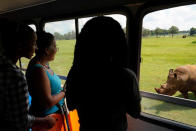 Un grupo de visitantes con audición parcial mira un rinoceronte blanco durante una visita al zoo nacional en La Habana, Cuba.