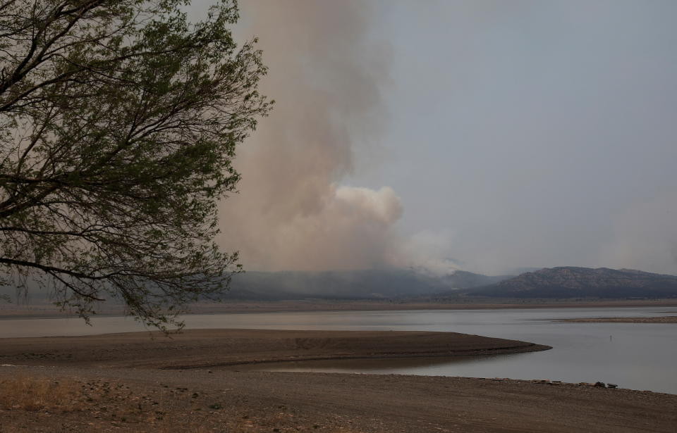 Smoke rises from the nearby Hermits Peak and Calf Canyon wildfires, at Storrie Lake State Park near Las Vegas, New Mexico on May 2, 2022.  (Adria Malcolm/Reuters)