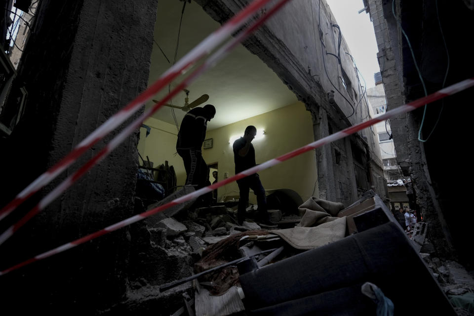 Palestinians inspect a damaged building following an Israeli army raid in the Balata refugee camp near the West Bank town of Nablus Monday, May 22, 2023. A Palestinian militant group said three members were killed in the raid. (AP Photo/Majdi Mohammed)