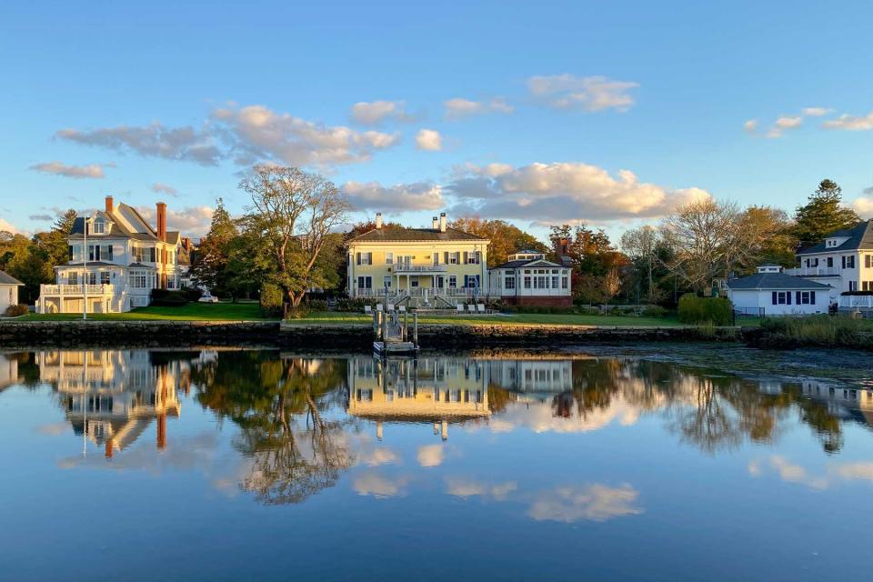 Sunset along the Mystic River in Mystic, Connecticut as reflections float above the still water.