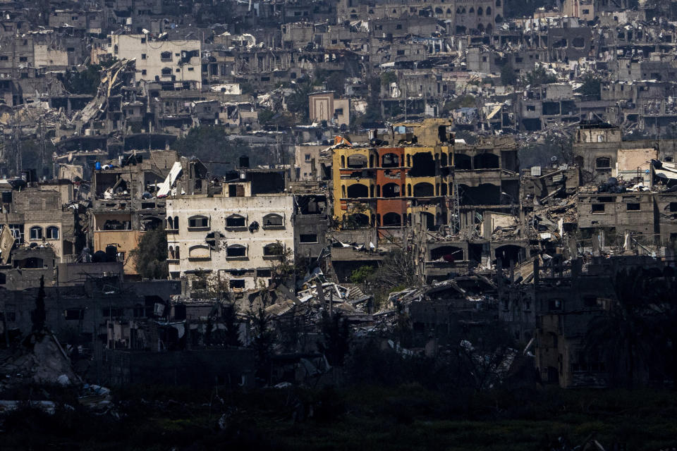 Destroyed buildings stand inside the Gaza Strip, as seen from southern Israel, Tuesday, March 19, 2024. (AP Photo/Ariel Schalit)