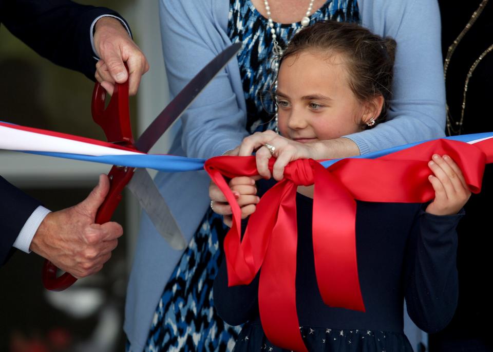 Santana Gagnon, 6, watches as a ribbon is cut in front of her new home, a triplex located in Gifford, Nov. 17, 2023. The triplex, which received $180,000 from Indian River County, part of $31 million that was allocated in the American Rescue Plan, will house three veteran families. The American Rescue Plan, a federal coronavirus relief bill signed into law in 2021, provided $1.9 trillion to individual households, and $350 billion to states, cities, counties and tribal governments. The most money on the Treasure Coast — $63.8 million — went to the largest government, St. Lucie County.