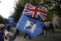 An anti-Brexit protester demonstrates outside the Houses of Parliament in London, Thursday, Sept. 26, 2019. British Prime Minister Boris Johnson faced a backlash from furious lawmakers Thursday over his use of charged and confrontational language in Parliament about opponents of his Brexit plan. (AP Photo/Matt Dunham)