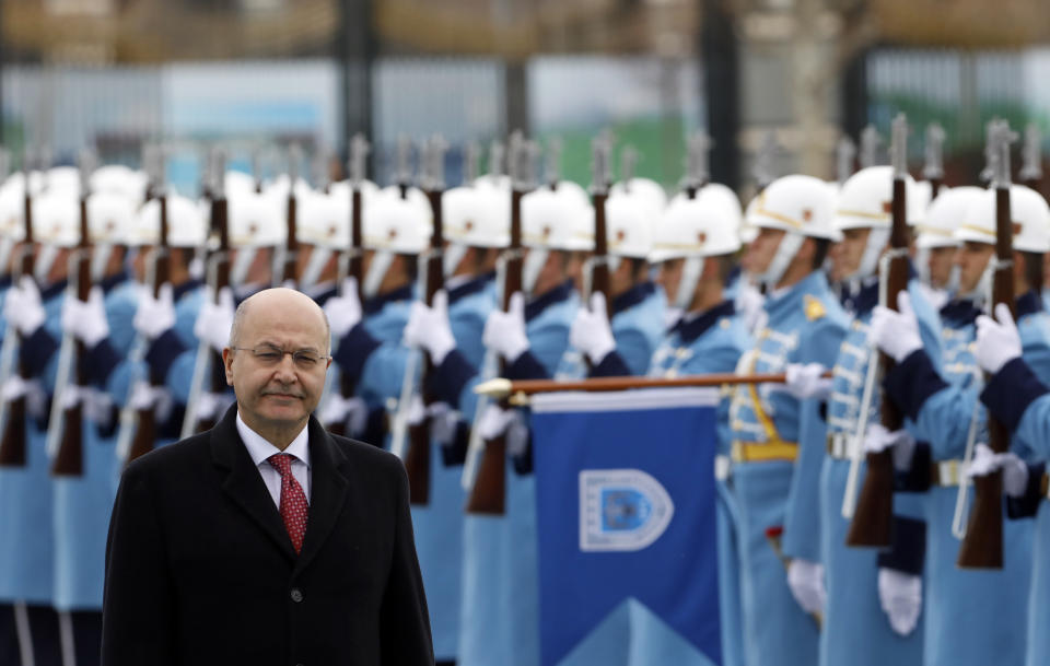 Iraq's President Barham Salih inspects a military honour guard before talks with Turkey's President Recep Tayyip Erdogan, in Ankara, Turkey, Thursday, Jan. 3, 2019. The two were expected to discus bilateral and regional issues, including Syria.(AP Photo/Burhan Ozbilici)