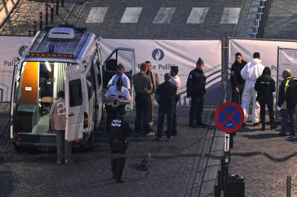 Police personnel are seen at the site of a shooting in Brussels