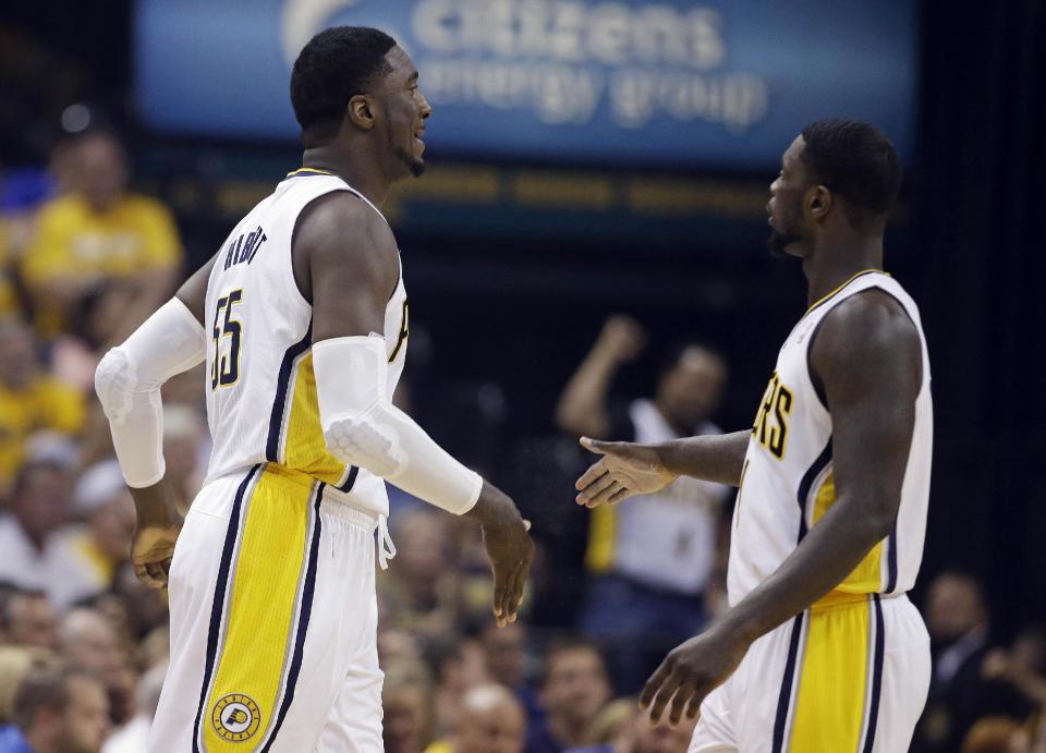 Indiana Pacers' Roy Hibbert, left, is congratulated by Indiana Pacers' Lance Stephenson after scoring a basket and getting fouled during the first half of game 2 of the Eastern Conference semifinal NBA basketball playoff series against the Washington Wizards, Wednesday, May 7, 2014, in Indianapolis. (AP Photo/Darron Cummings)