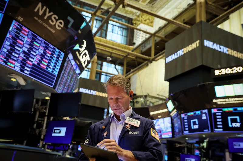 Traders work on the floor of the NYSE in New York