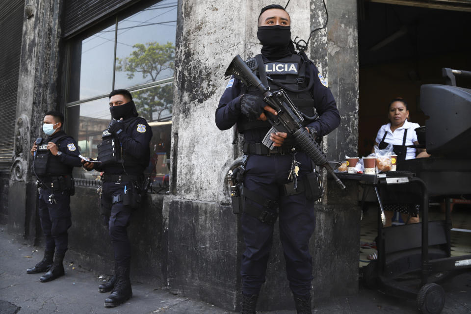 Heavily armed police guard the streets in down town San Salvador, El Salvador, Sunday, March 27, 2022. El Salvador's congress has granted President Nayib Bukele request to declare a state of emergency, amid a wave of gang-related killings over the weekend. (AP Photo/Salvador Melendez)