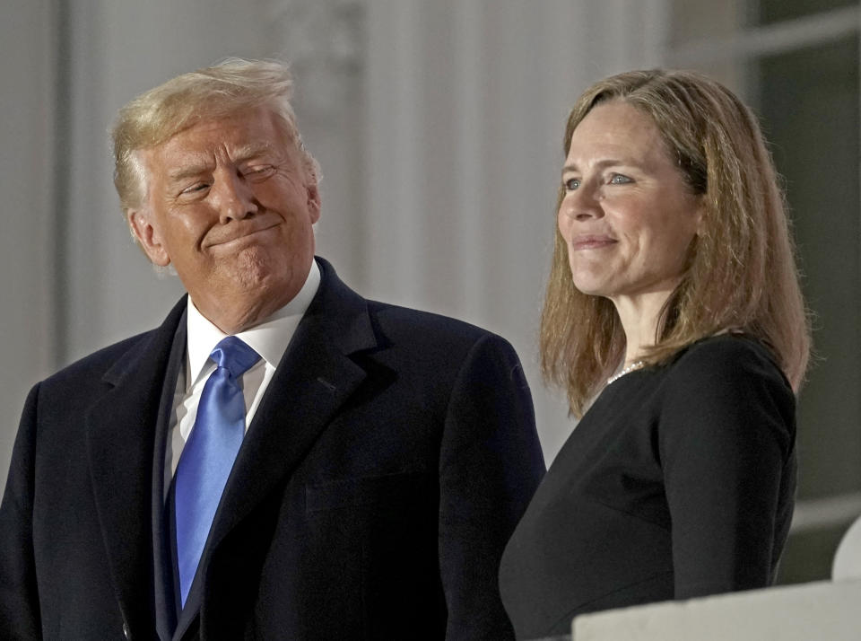 Bloomberg Best of the Year 2020: U.S. President Donald Trump, left, and Amy Coney Barrett, associate justice of the U.S. Supreme Court, on a balcony during a ceremony on the South Lawn of the White House in Washington, D.C., U.S., on Monday, Oct. 26, 2020. (Ken Cedeno/CNP/Bloomberg via Getty Images)