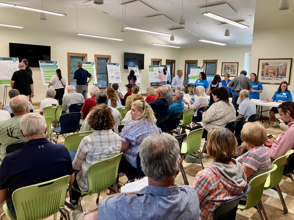 Residents view the Framework presentation and provide public input Wednesday at the Mary E. Babcock Library in Johnstown.