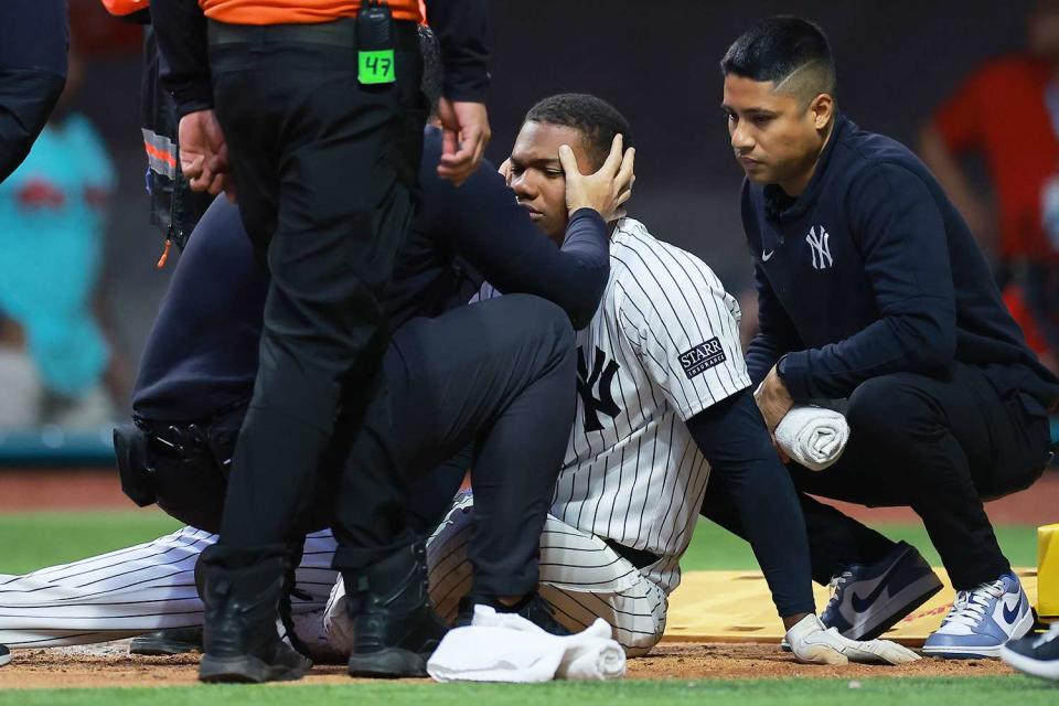 <p>Hector Vivas/Getty</p> Oscar Gonzalez getting checked by doctors