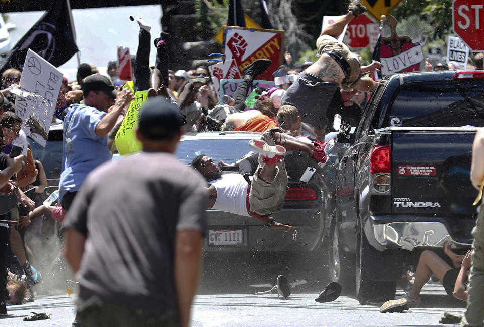 <p>People fly into the air as a vehicle drives into counterprotesters demonstrating against a white nationalist rally in Charlottesville, Va., on Aug. 12, 2017. (Photo: Ryan M. Kelly/The Daily Progress via AP) </p>