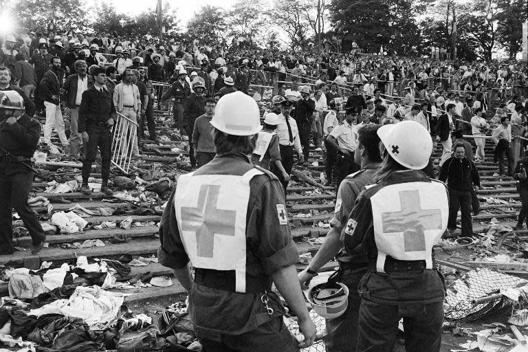 Rescuers evacuate football fans at Heysel stadium in Brussels on May 29, 2015