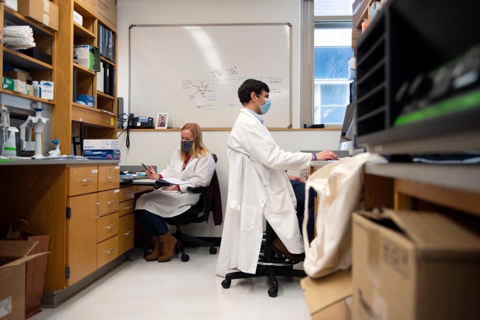 Dr. David Fajgenbaum, right, and Dr. Melanie Mumau work in their lab at the University of Pennsylvania Friday, Dec. 10, 2021 in Philadelphia, PA.