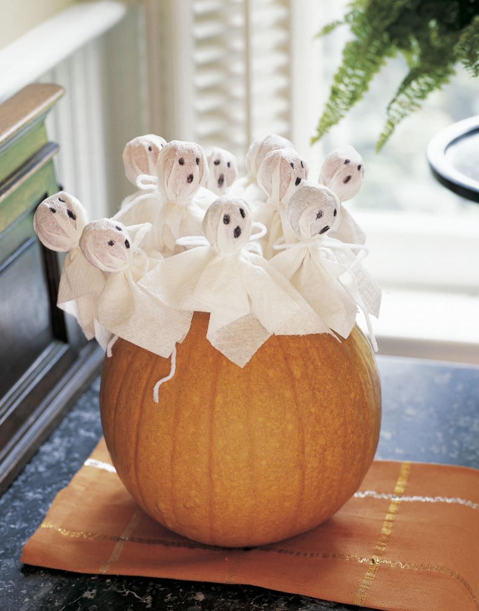 <p>Fill your hollowed-out gourd with dressed-up lollipops. It'll double as cute decor and a handy trick-or-treating bowl.</p>