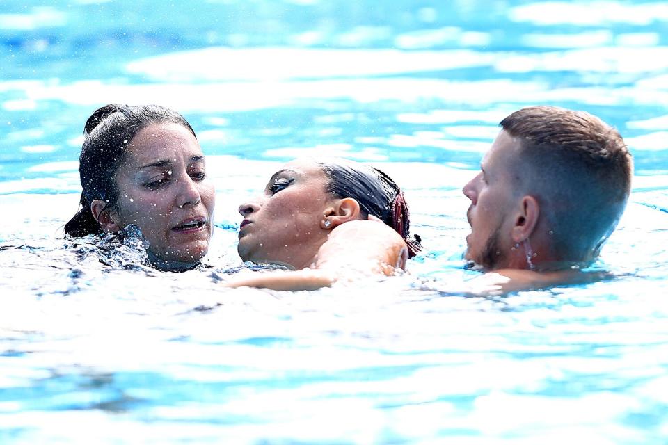 Anita Alvarez (C) of Team United States is attended to by USA's coach Andrea Fuentes (L) and medical staff following her Women's Solo Free Final performance on day six of the Budapest 2022 FINA World Championships at Alfred Hajos National Aquatics Complex on June 22, 2022 in Budapest, Hungary.