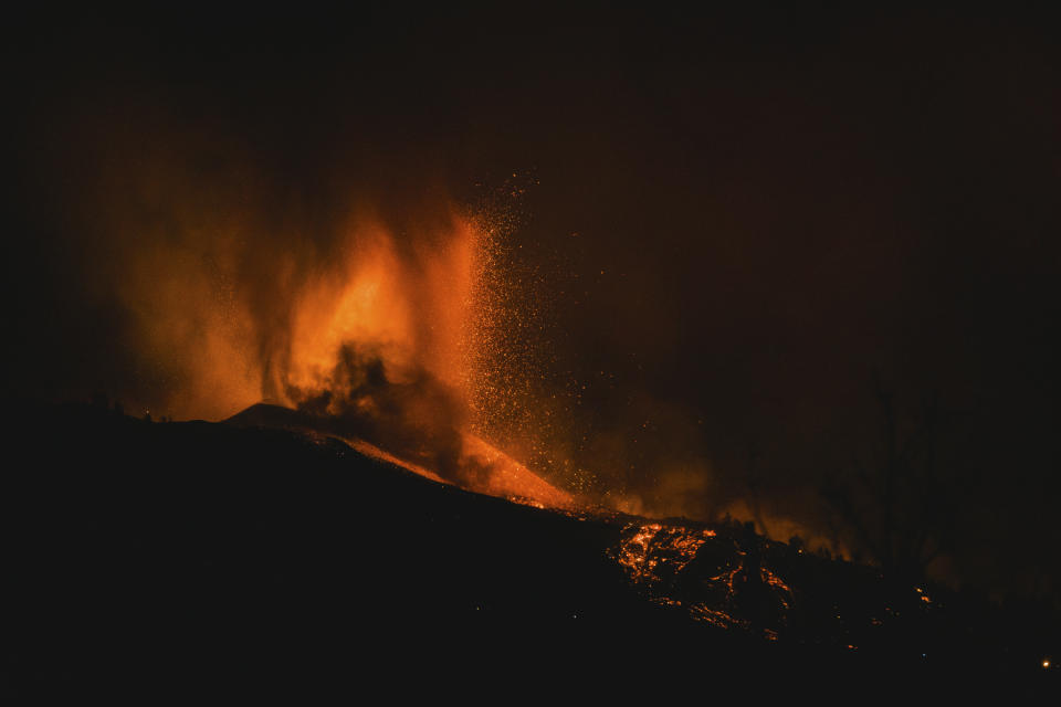 Lava flows from an eruption of a volcano near El Paso on the island of La Palma in the Canaries, Spain, in the early hours of Monday, Sept. 20, 2021. Lava continues to flow slowly from a volcano that erupted in Spain’s Canary Islands off northwest Africa. The head of the islands' regional government says Monday he expects no injuries to people in the area after some 5,000 were evacuated. (AP Photo/Jonathan Rodriguez)