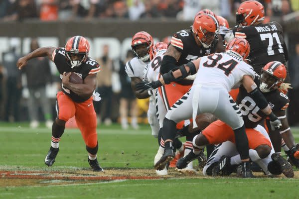 Cleveland Browns running back Nick Chubb (L) runs past the Cincinnati Bengals defense Sunday in Cleveland. Photo by Aaron Josefczyk/UPI