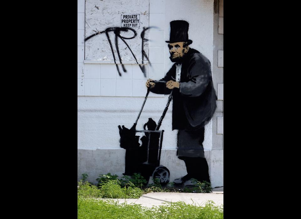 NEW ORLEANS - AUGUST 28:  Grafitti by the illusive artist Banksy adorns a closed shop August 28, 2008 in New Orleans, Louisiana. New works by the artist, whose paintings are also sold in galleries,  have been popping up throughout New Orleans coinciding with the third anniversary of Hurricane Katrina.  (Photo by Sean Gardner/Getty Images)