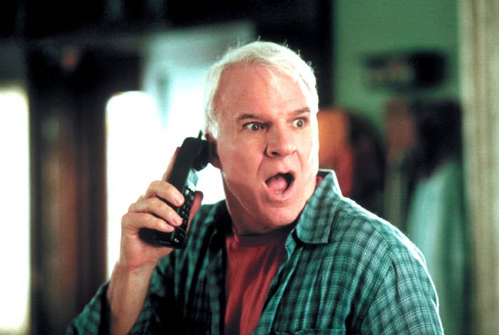 Steve Martin looking shocked while he holds a phone in Cheaper by the Dozen