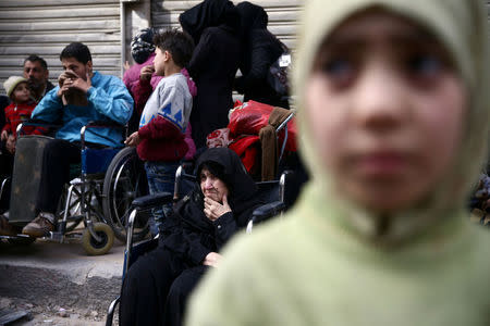 An elderly woman sits in a wheelchair in the besieged town of Douma, Eastern Ghouta, in Damascus, Syria March 15, 2018. REUTERS/Bassam Khabieh