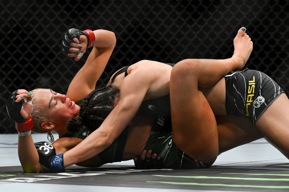 Jul 22, 2023; London, UNITED KINGDOM; Shauna Bannon (red gloves) fights Bruna Brasil (blue gloves) during UFC Fight Night at O2 Arena. Mandatory Credit: Per Haljestam-USA TODAY Sports