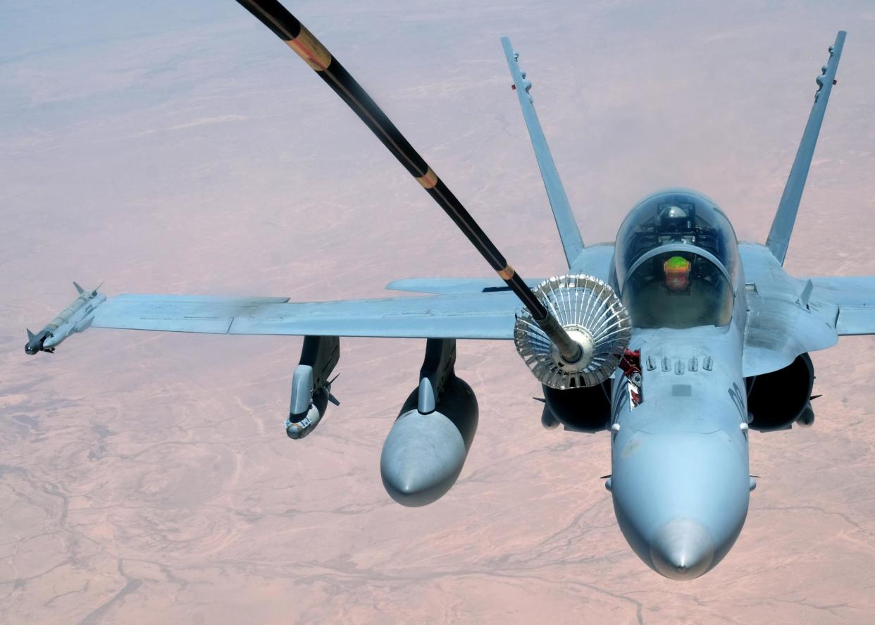 A US Marine Corps F-18 Super Hornet receives fuel from a 908th Expeditionary Air Refueling Squadron KC-10 Extender on 31 May 2017, over an undisclosed location above Syrian or Iraqi airspace: Reuters