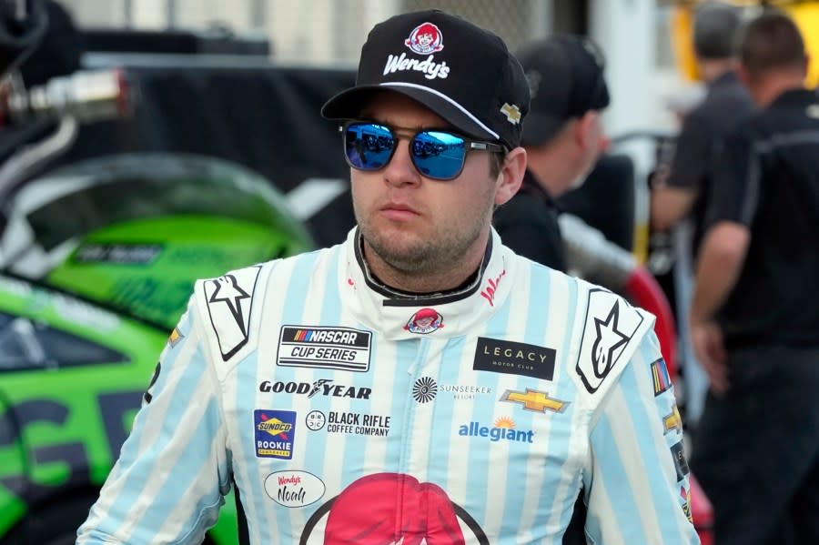 FILE – Noah Gragson walks to his garage during a practice session for the NASCAR Daytona 500 auto race at Daytona International Speedway, Friday, Feb. 17, 2023, in Daytona Beach, Fla. Gragson has been suspended indefinitely by NASCAR and Legacy Motor Club due to undisclosed activity on social media.(AP Photo/John Raoux, File)