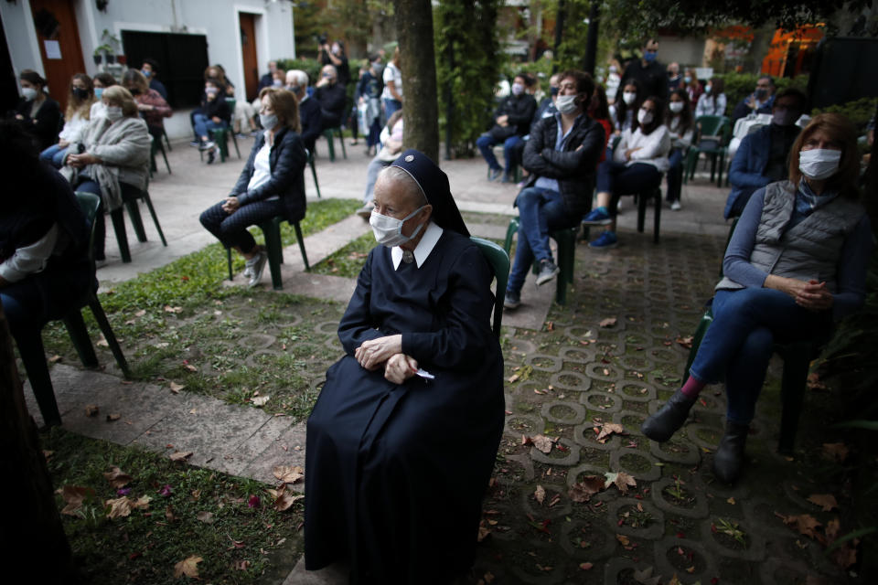 Faithful attend Mass outside the Schoenstatt shrine during Easter in Buenos Aires, Argentina, Thursday, April 1, 2021. The Mass was held outside to avoid the spreading of COVID-19. (AP Photo/Natacha Pisarenko)