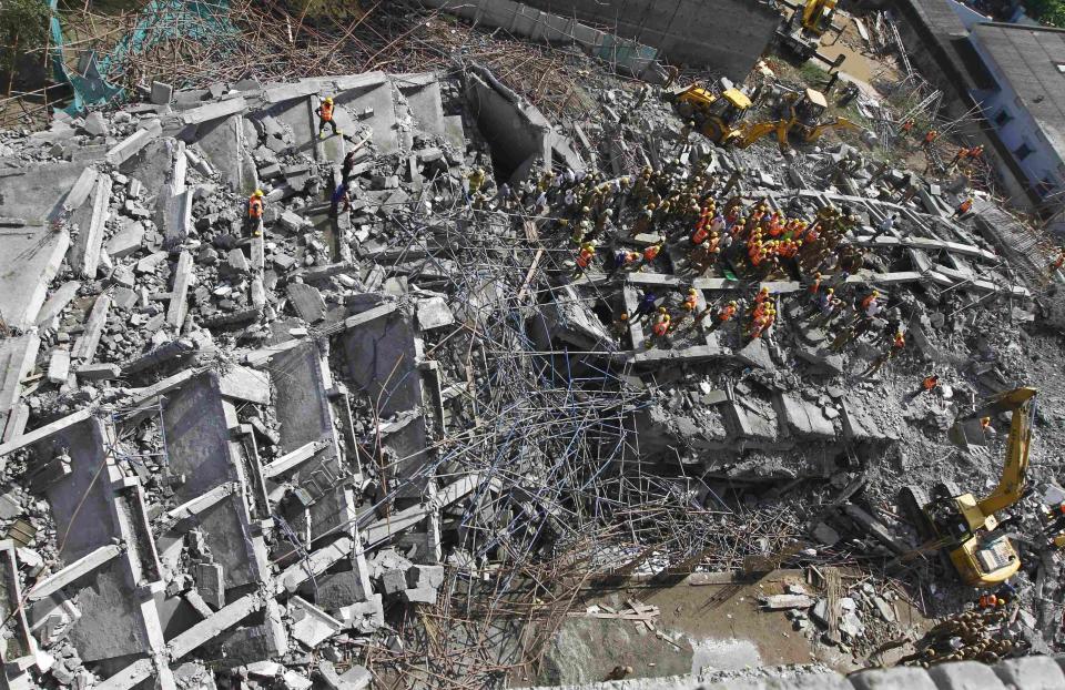 Rescue workers conduct a search operation for survivors at the site of a collapsed 11-storey building that was under construction on the outskirts of Chennai