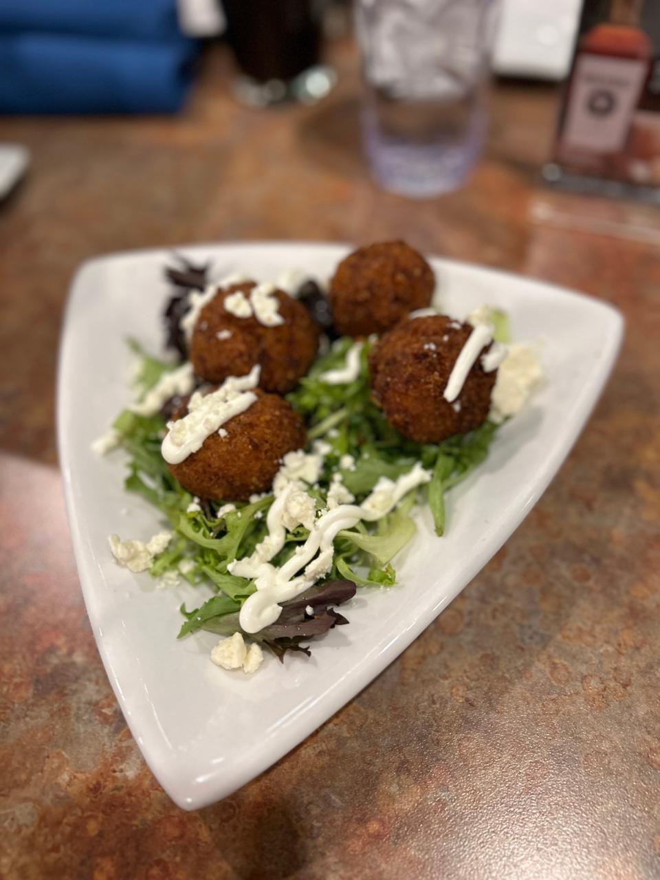 Brew Yard Balls are made with chorizo, risotto, white cheddar, lime crema and queso fresco at Caston & Main Brew Yard.