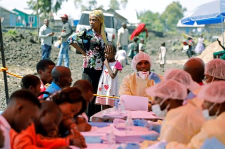 FILE PHOTO: A woman and child wait to receive the Ebola vaccination in Goma
