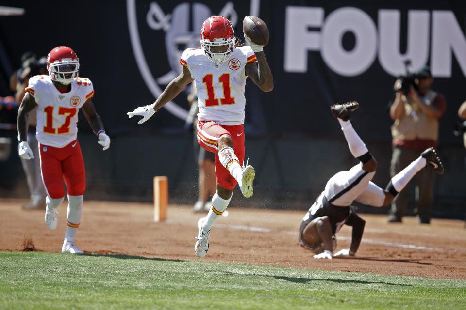 Kansas City Chiefs wide receiver Demarcus Robinson (11) celebrates after scoring a touchdown as teammate Mecole Hardman (17) looks on during the first half of an NFL football game against the Oakland Raiders Sunday, Sept. 15, 2019, in Oakland, Calif. At right is Oakland Raiders cornerback Gareon Conley. (AP Photo/Ben Margot)