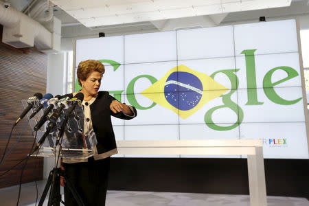 Brazil President Dilma Rousseff checks her watch as she addresses the media during her visit at Google headquarters in Mountain View, California July 1, 2015. REUTERS/Stephen Lam