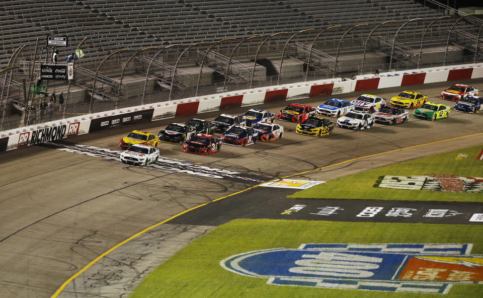 Kevin Harvick leads drivers to the starting line as the green flag is dropped to begin a NASCAR Cup Series auto race Saturday, Sept. 12, 2020, in Richmond, Va. (James Wallace/Richmond Times-Dispatch via AP)