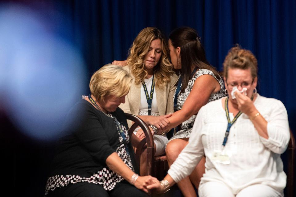 Survivors comfort each other while Pennsylvania Attorney General Josh Shapiro outlined the findings of the grand jury investigation into six Catholic dioceses in the state Aug. 14, 2018. The grand jury's report detailed child sexual abuse and cover-up by more than 300 clergy.
