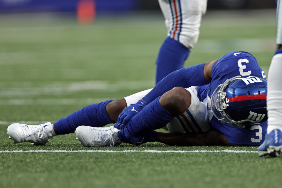 New York Giants wide receiver Sterling Shepard (3) grabs his ankle against the Dallas Cowboys during an NFL football game, Sunday, Dec. 19, 2021, in East Rutherford, N.J. (AP Photo/Adam Hunger)