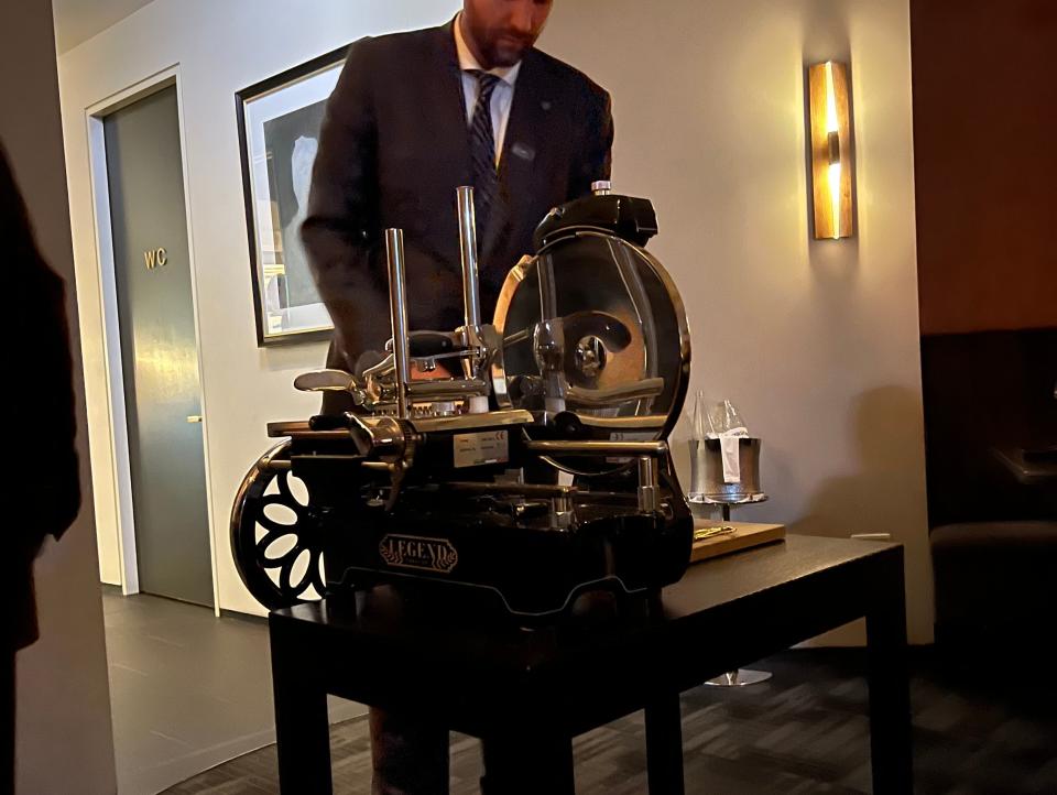 a server putting something into a cranking machine in the dining room