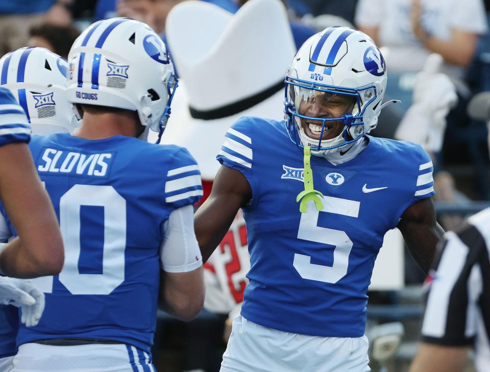 Brigham Young Cougars wide receiver Darius Lassiter (5) celebrates his touchdown with Brigham Young Cougars quarterback Kedon Slovis (10) in Provo on Saturday, Oct. 21, 2023. | Jeffrey D. Allred, Deseret News