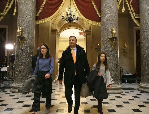 Congressman Sean Casten with his daughters Gwen, left, and Audrey, walk through the U.S. Capitol Building on Jan. 4, 2019. (Photo: Chicago Tribune via Getty Images)