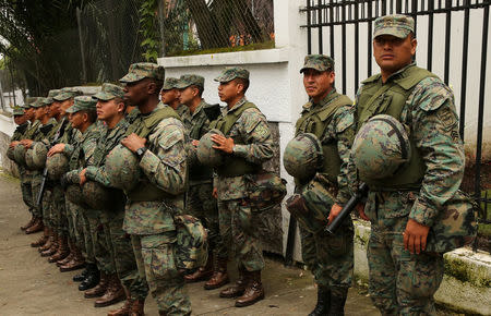 Soldiers stand near the Electoral National Council (CNE) headquarters prior to Sunday presidential election in Quito, Ecuador, April 1, 2017. REUTERS/Mariana Bazo