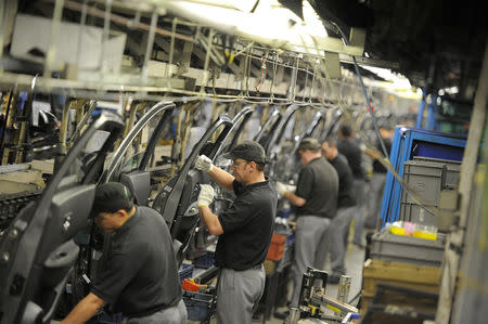 FILE PHOTO: Nissan technicians prepare doors for the Qashqai car at the company's plant in Sunderland, Britain, November 9, 2011. REUTERS/Nigel Roddis/File Photo