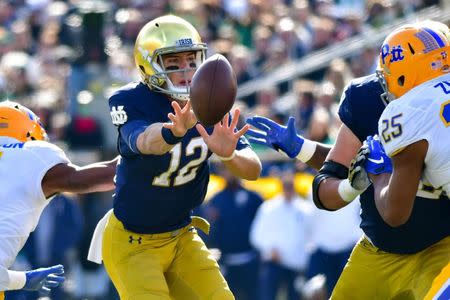 Oct 13, 2018; South Bend, IN, USA; Notre Dame Fighting Irish quarterback Ian Book (12) pitches the ball in the second quarter against the Pittsburgh Panthers at Notre Dame Stadium. Mandatory Credit: Matt Cashore-USA TODAY Sports