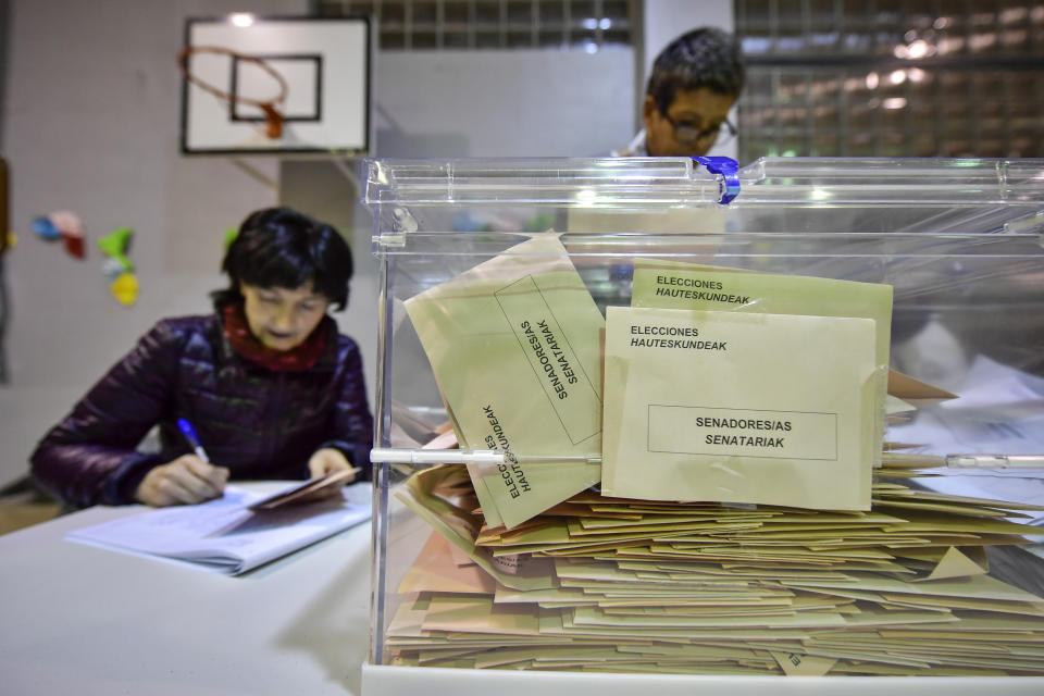 Election officials prepare to count the votes at a polling station for the general election, in Pamplona, northern Spain, Sunday, Nov. 10, 2019. As Spaniards voted Sunday in the country’s fourth election in as many years, a leading leftist party pledged to help the incumbent Socialists in hopes of staving off a possible right-wing coalition government that could include a far-right party. (AP Photo/Alvaro Barrientos)