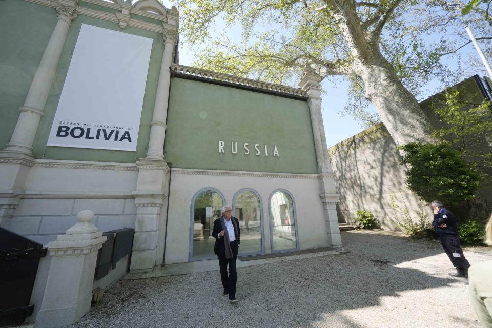 A visitor walks in front of the Russian pavilion at the 60th Biennale of Arts exhibition in Venice, Italy, Tuesday, April 16, 2024. The Venice Biennale contemporary art exhibition opens Saturday for its six-month run through Nov. 26. The main show titled "Stranieri Ovunque – Foreigners Everywhere," is curated for the first time by a Latin American, Brazilian Adriano Pedrosa. Pedrosa is putting a focus on underrepresented artists from the global south, along with gay and Indigenous artists. Alongside the main exhibition, 88 national pavilions fan out from the traditional venue in Venice's Giardini, to the Arsenale and other locations scattered throughout the lagoon city. (AP Photo/Luca Bruno)