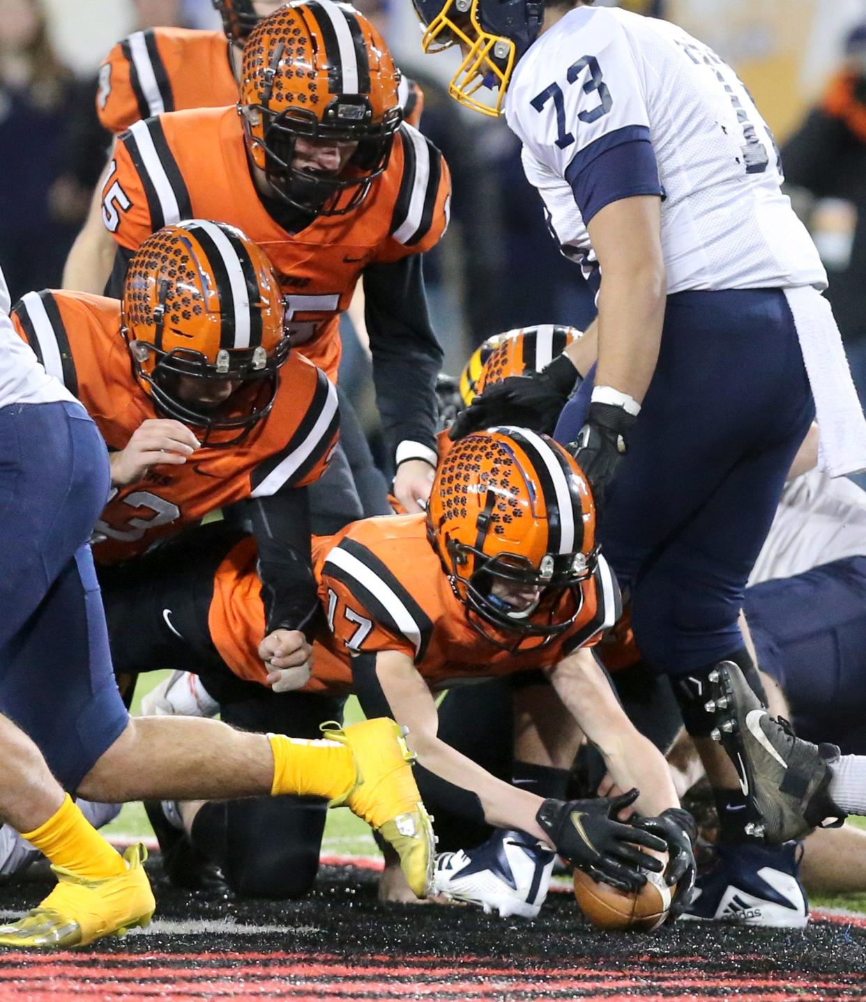 Michael Osborne, 17, of Versailles recovers a fumble  during their DV state championship game against Kirtland at Tom Benson Hall of Fame Stadium on Saturday, Dec. 4, 2021.