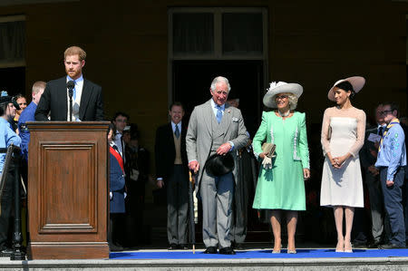 Britain's Prince Harry and his wife Meghan, Duchess of Sussex, at a garden party at Buckingham Palace with Prince Charles and Camilla the Duchess of Cornwall, their first royal engagement as a married couple, in London, May 22, 2018. Dominic Lipinski/Pool via Reuters