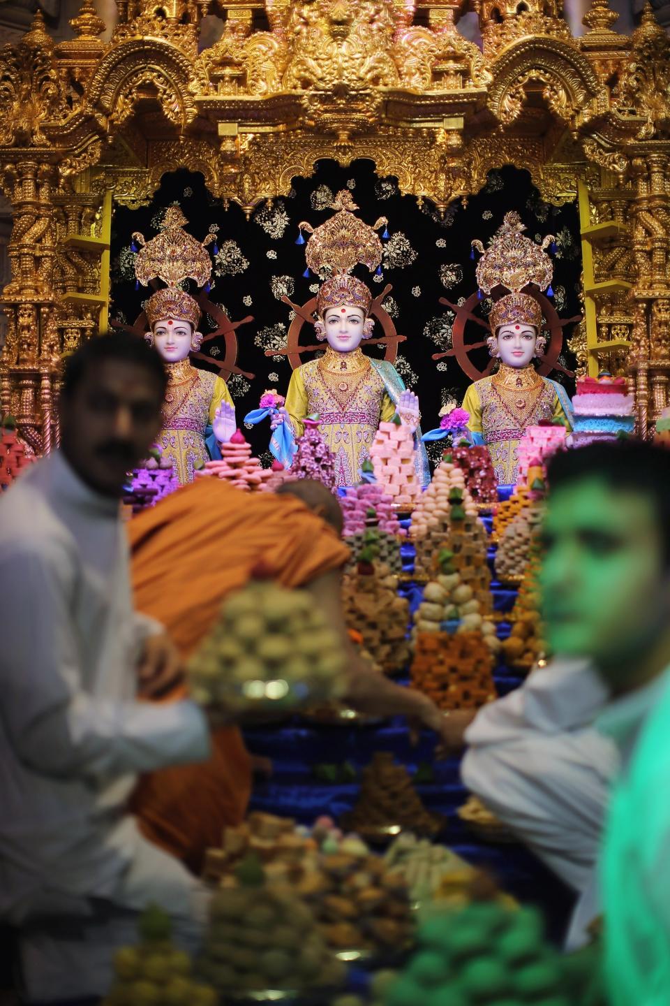 LONDON, ENGLAND - NOVEMBER 14: Final preperations are made inside the shrine ahead of a ceremony as Sadhus and Hindus celebrate Diwali at the BAPS Shri Swaminarayan Mandir on November 14, 2011 in London, England. Diwali, which marks the start of the Hindu New Year, is being celebrated by thousands of Hindu men women and children in the Neasden mandir, which was the first traditional Hindu temple to open in Europe. (Photo by Dan Kitwood/Getty Images)