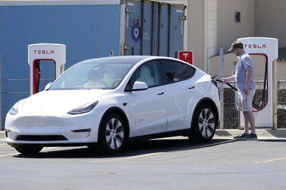 A Tesla owner charges his vehicle at a charging station in Topeka, Kan., Monday, April 5, 2021. The president and the auto industry maintain the nation is on the cusp of a gigantic shift to electric vehicles and away from liquid-fueled cars, but biofuels producers and some of their supporters in Congress aren’t buying it. They argue the U.S. should increase sales of ethanol and biodiesel, not abandon them. (AP Photo/Orlin Wagner)