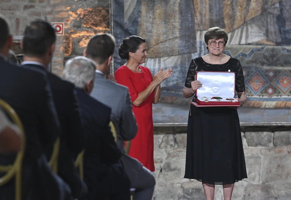 FILE - Hungarian biochemist Katalin Kariko receives the highest state honour, the Grand Cross of the Hungarian Order of Saint Stephen from Hungarian President Katalin Novak, second right, in the Esztergom Basilica in Esztergom, northern Hungary, Sunday, Aug. 20, 2023. Two scientists have won the Nobel Prize in medicine on Monday, Oct. 2, 2023 for discoveries that enabled the development of mRNA vaccines against COVID-19. The award was given to Katalin Karikó and Drew Weissman. Karikó is a professor at Sagan’s University in Hungary and an adjunct professor at the University of Pennsylvania. (Noemi Bruzak/MTI via AP, File)